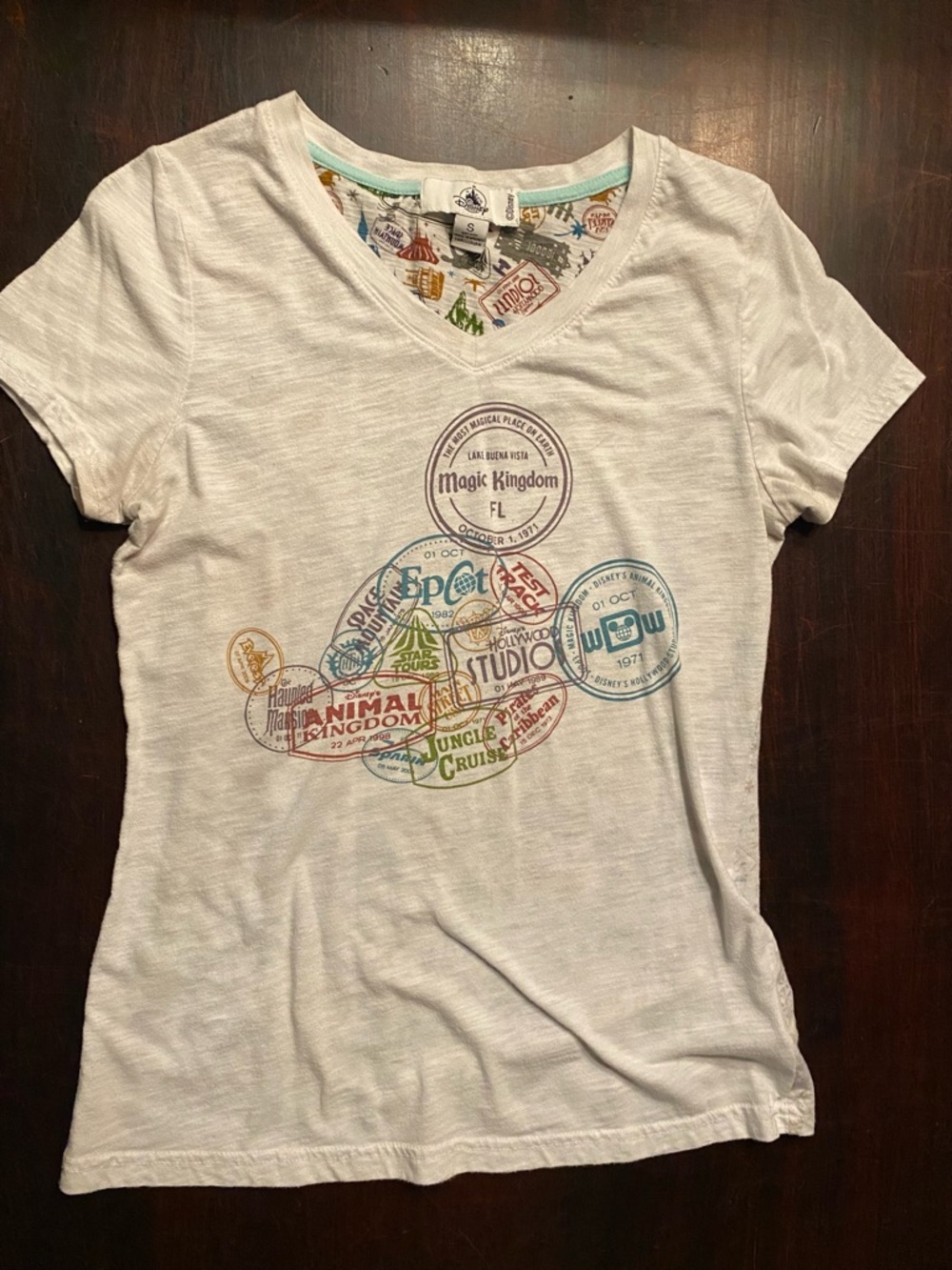 Disney White V-Neck Short Sleeve Tee with Multicolor Theme Park Print